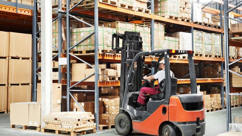 Truck som flytter paller i lager